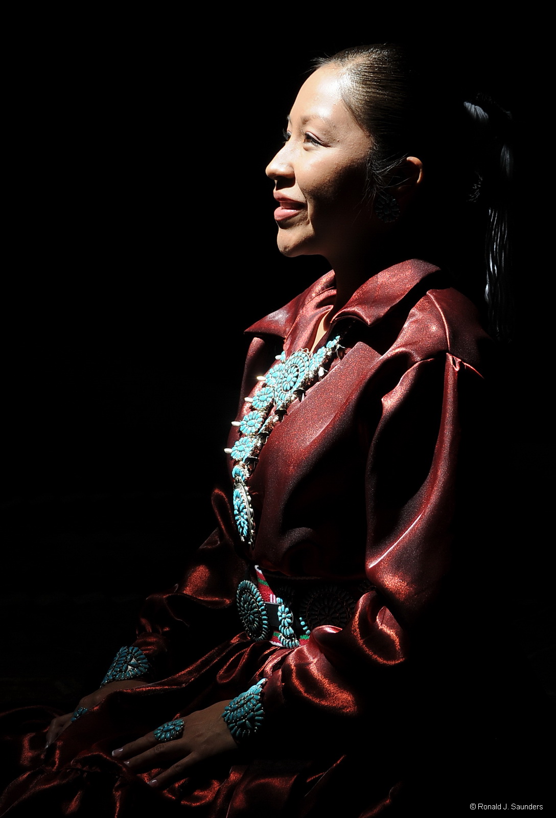 A Navajo girl poses in the light entering the top of the Hogan.&nbsp;