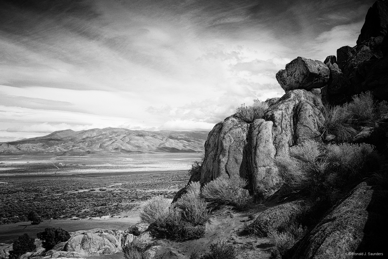 This image gives me the feeling of the old west and remoteness. The Winnemucca Valley stretches to the clouds and hills in the...